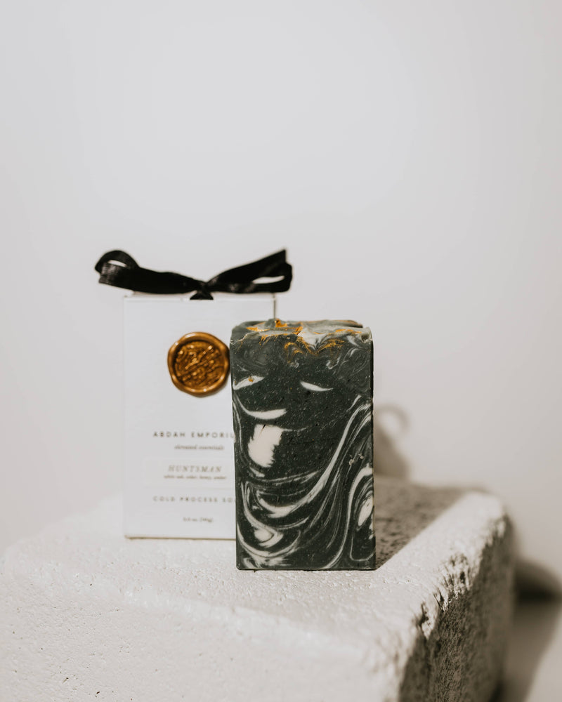Marble-patterned soap with a black ribbon on a textured box