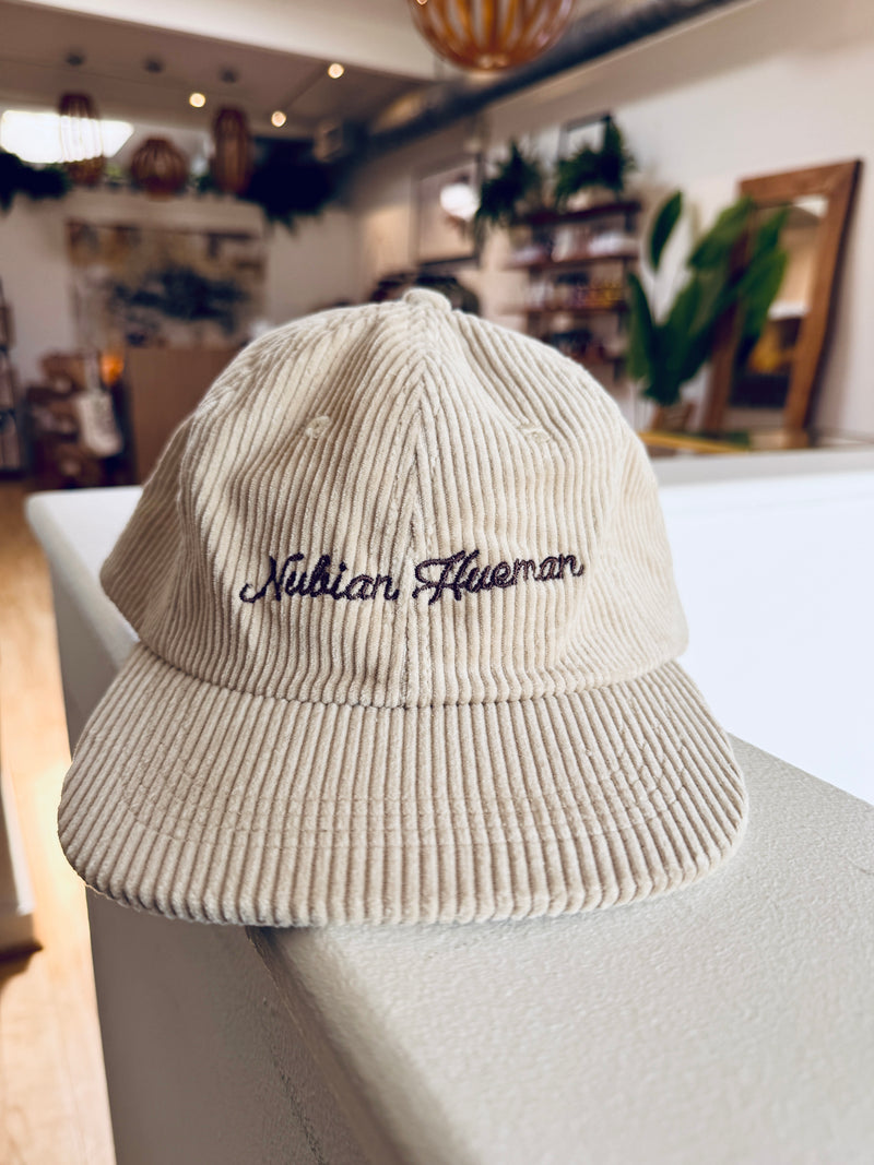 Beige corduroy hat with embroidered text 